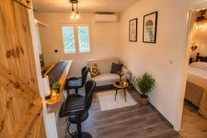 a small living room with a couch and a bed at Panoramic view with jacuzzi in Vis