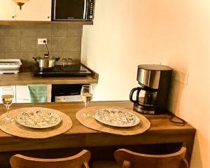 a table with two plates and glasses of wine at Apartamento de confort en el Centro Histórico de Cusco in Cusco +12 photos