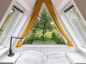 a bed in a room with a large window at 4 star holiday home in Farsø in Farsø