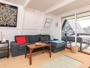 a living room with a couch and a table at 4 star holiday home in Farsø in Farsø