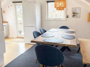 a kitchen and dining room with a table and chairs at Bright Cottage with Hot Tub in Ebeltoft +20 photos