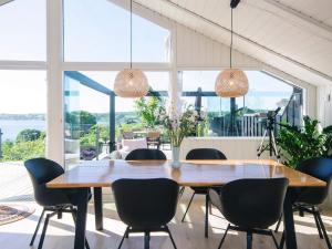 a dining room with a wooden table and chairs at 5 star holiday home in Kolding in Kolding