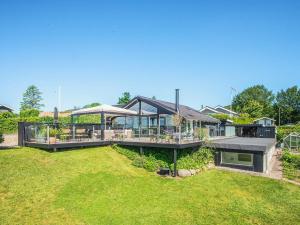 a large house with a large deck in a yard at 5 star holiday home in Kolding in Kolding