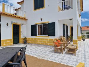 a patio of a house with chairs and a table at Sol e Mar by the airport in Santa Cruz +91 photos