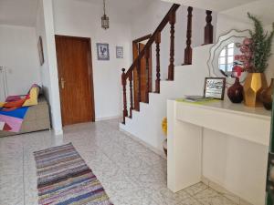 a living room with a staircase and a mirror at Sol e Mar by the airport in Santa Cruz