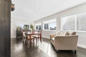 a living room with a table and chairs at Bright Coquitlam Home & Spacious Backyard in Coquitlam