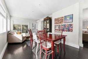 a living room with a dining room table and chairs at Bright Coquitlam Home & Spacious Backyard in Coquitlam +46 photos