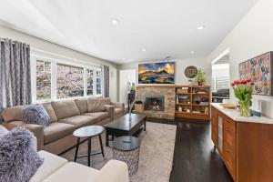 a living room with a couch and a fireplace at Bright Coquitlam Home & Spacious Backyard in Coquitlam