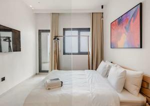 a bedroom with a large white bed with a clear box on it at The Blue Mirage in Tangier