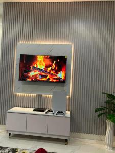 a living room with a tv on a wall at Abadel Homes in Ikeja