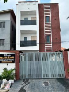 a white fence in front of a building at Abadel Homes in Ikeja