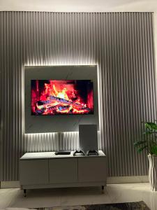 a living room with a tv on a wall at Abadel Homes in Ikeja