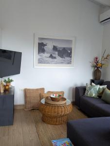 a living room with a couch and a table at 2 Bedroom Dream Cottage-Point Blanche in Philipsburg