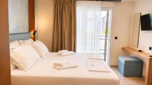 a hotel room with a bed with towels on it at Studios Maria - Renovating Brand New for 2026 in Potos
