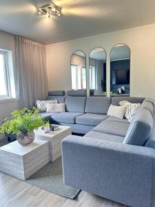 a living room with a blue couch and mirrors at Villa Myklebust in Olden