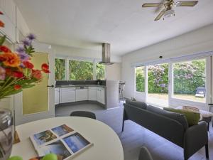 a living room with a table and a kitchen at Brabants licht in Lage Mierde