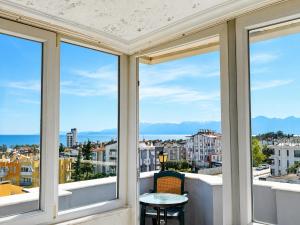 a balcony with windows and a table and chairs at Luna Hotel in Antalya