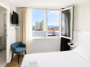 a hotel room with a bed and a window at Luna Hotel in Antalya