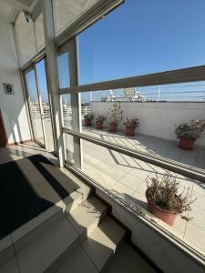 a balcony with potted plants and a view of a patio at Hermoso Depto Central in Rancagua