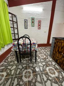 a room with a table and a chair on a rug at Monoambiente LPS in Santiago del Estero