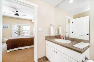 a bathroom with a sink and a bed at Base Camp One 201 in Granby +42 photos