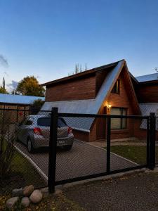 a house with a car parked in front of it at Cabañas Chucao 2 in San Martín de los Andes