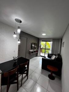 a living room with a table and a couch at VG Cumbuco J&Y in Caucaia