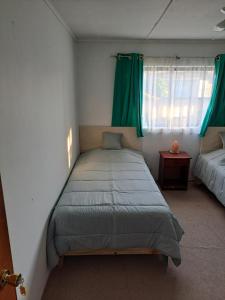 a bedroom with a bed and a window with green curtains at Geranio Bed & Breakfast in Casablanca +25 photos