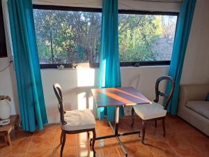 a table and chairs in a room with a window at Geranio Bed & Breakfast in Casablanca