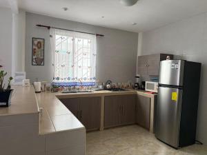 a kitchen with a stainless steel refrigerator and a window at Cabaña Mar Olon Renovation in Olón