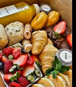 a box filled with different types of pastries and fruit at Feeling Porto House in Porto +17 photos