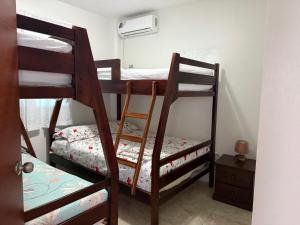a room with three bunk beds in a room at Cabaña Mar Olon Renovation in Olón +8 photos