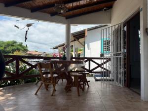 a patio with a table and chairs on a balcony at Cabaña Mar Olon Renovation in Olón
