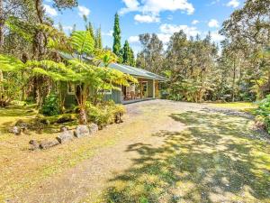an estate with a house and a driveway at Charming Tiny Cottage 5 min from National Park in Volcano