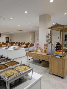 a cafeteria with many trays of food on display at Fuji Mountain Resort Hotel in Fujikawaguchiko