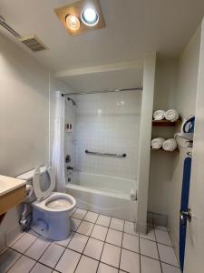 a bathroom with a toilet and a shower and a sink at Jolly Roger Hotel in Los Angeles +16 photos