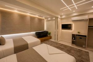 a hotel room with a bed and a flat screen tv at Vincci Pyramids View in Cairo +51 photos