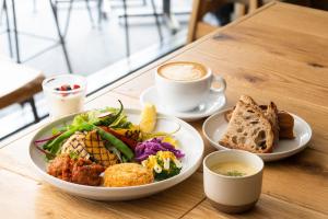 a table with a plate of food and a cup of coffee at HOTEL RINGS KYOTO in Kyoto +33 photos
