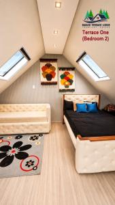a attic bedroom with a bed and a rug at Baguio Terrace Lodge in Baguio