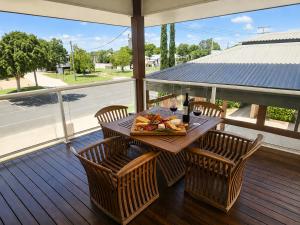 a table with a plate of food on a porch at Emerald Inn by Travellers in Emerald