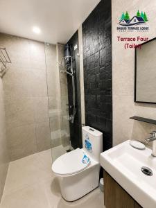 a bathroom with a toilet and a sink and a shower at Baguio Terrace Lodge in Baguio +20 photos