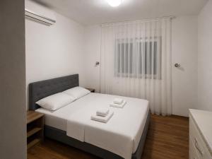 a bedroom with a bed with two towels on it at Sobe Ivan-Popić in Međugorje +17 photos