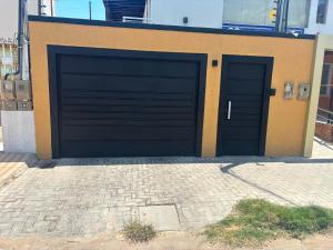 a pair of garage doors on a building at Suites Coliseu 40-A in Petrolina