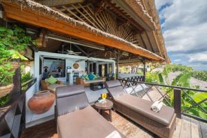 an outdoor patio of a resort with chairs and tables at Villa Atas Lembongan in Nusa Lembongan