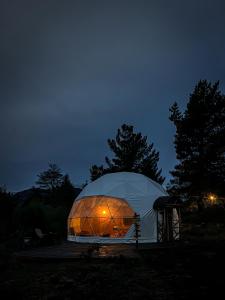 a dome tent with a light inside at night at Lodge Domos Awen in Pucón