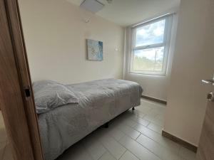 a bedroom with a bed and a window at Angies Loft in Tegucigalpa