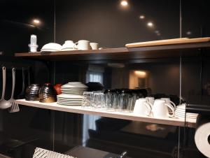 a shelf with plates and dishes in a kitchen at WinGoodDays in Kumamoto