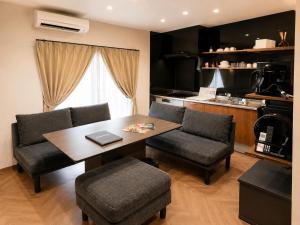a kitchen with a dining room table and chairs at WinGoodDays in Kumamoto