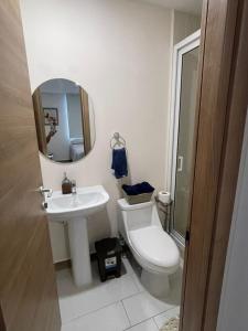 a bathroom with a toilet and a sink and a mirror at Angies Loft in Tegucigalpa +29 photos