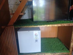 a refrigerator sitting on a shelf next to a microwave at Vagamon leafmist frame cabin in Vagamon